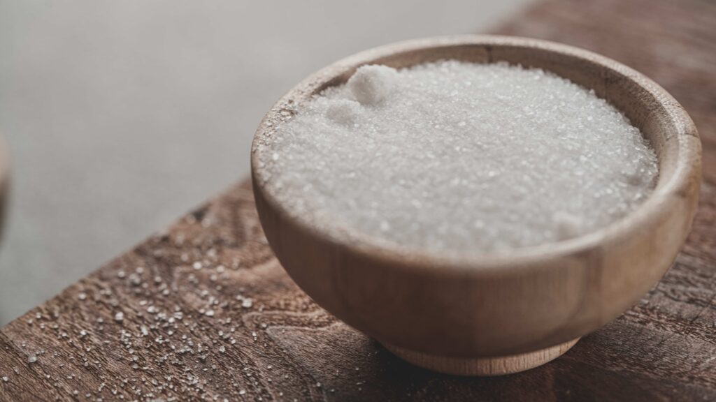 Image showing a bowl of white sugar. In some countries, white sugar is processed with animal bones.